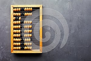 Accounting abacus on gray textured background