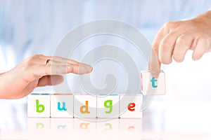 Accounting banking finance or business concept. Male hands collect word Budget from cubes