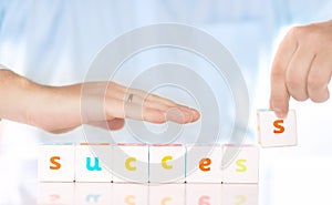 Accounting banking finance or business concept. Male hands collect word success from cubes