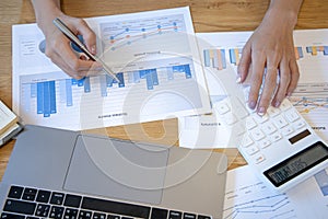 Accounting businesswomen are calculating income-expenditure and analyzing real estate investment data photo