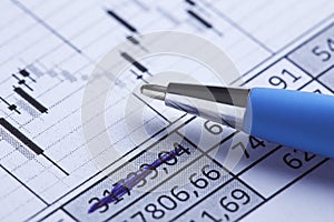 Accounting document with pen, share listing and checking financial chart. Concept of banking, financial report and financial audit