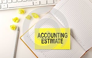 ACCOUNTING ESTIMATE text on sticker on the diary with keyboard and pencil