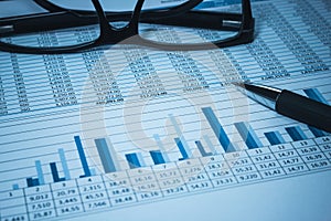 Accounting financial bank banking account stock spreadsheet data with glasses in blue accountant
