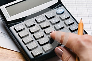 Accounting, financial concept, flat lay, calculator and pensil on wooden table