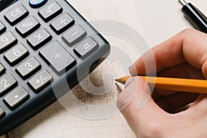 Accounting, financial concept, flat lay, calculator and pensil on wooden table