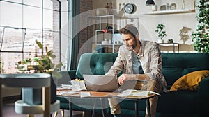 Accounting at Home: Streessed Man Using Laptop Computer, Filling Tax Forms. Businessman Scared of