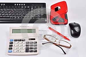 Accounting: invoice, keyboard, calculator, mouse, hole punch, glasses and red pen