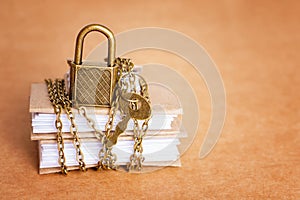 Accounting journals secured with chain and padlock