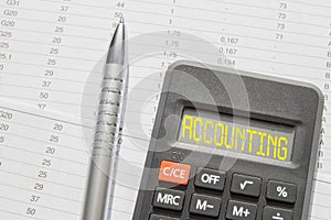 Accounting is written on a calculator, a pen on paper financial reports