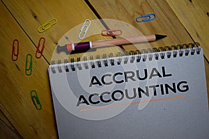 Accrual Accounting write on a book isolated on wooden background