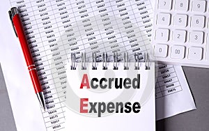 ACCRUED EXPENSE text on notebook with chart , pen and calculator