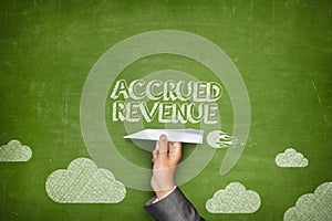 Accrued revenue concept on blackboard with paper plane