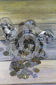 Accumulated coins stacked in glass jars