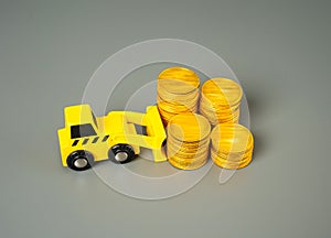 Accumulation of money and savings. A forklift pushes money coins into a stack. photo