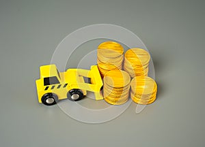 Accumulation of money and savings. A forklift pushes money coins into a stack.