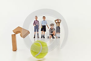 Accuracy. Group of kids, boys, children in classical retro clothes playing together over grey studio background. Concept