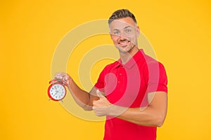 Accuracy and precision. Happy man hold alarm clock showing thumbs up. Punctuality and accurate timekeeping. Accuracy