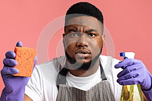 Accurate Black Couple Holding Cleaning Tools And Looking Suspiciosly At Camera