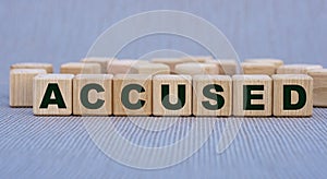 ACCUSED - word on wooden cubes on a beautiful gray background