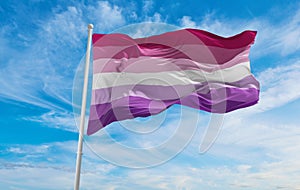 ace lesbian pride flag waving in the wind at cloudy sky. Freedom and love concept. Pride month. activism, community and freedom