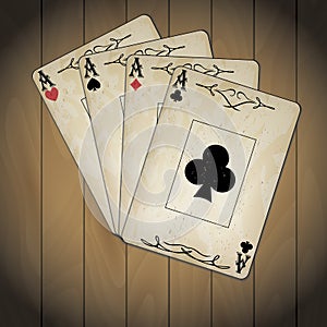 Ace of spades, ace of hearts, ace of diamonds, ace of clubs poker cards old look varnished wood background