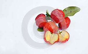 Acerola Cherry with half slice and green leaves isolated on white background