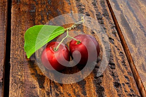 Acerola Cherry raw, fresh, on rustic wooden table, High vitamin C and antioxidant fruits