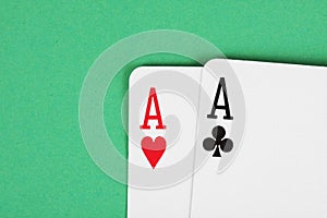 Aces playing cards detail on green table