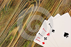 Aces on the wooden background of the game table.