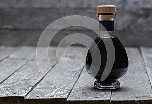 Aceto balsamico on old gray wood