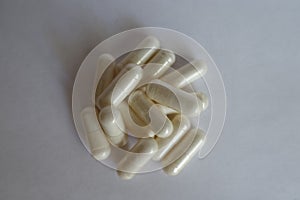 Acetyl L-Carnitine capsules on neutral background photo