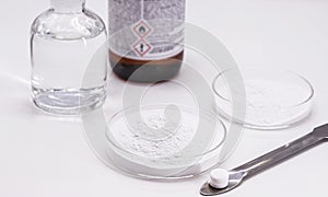 Acetylsalicylic acid powder being produced in the laboratory, inside a petri dish, medicine obtained from salicylic acid and