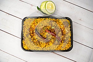 Achari beef khichuri biryani rice pulao with cucumber and lemon slice served in dish isolated on wooden table top view of