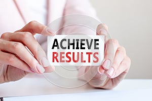 Achieve results written on a card in woman hands