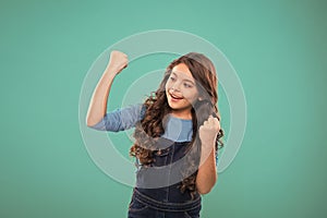 Achieve success. Kid cheerful celebrate victory. Girl cute child long curly hair happy smiling. Child psychology and