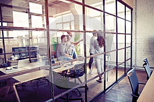 Achieving best results. Modern young man conducting a business presentation while standing behind the glass wall in the