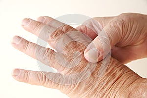 Aching knuckle on older man photo