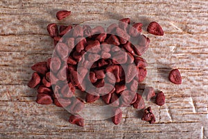 Achiote seeds closeup on balsa wood