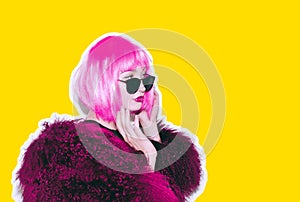 Acid crazy hot beautiful rock Girl in bright pink wig and sunglasses in lama leather swag style red fur winter coat