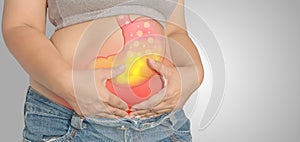 Acid reflux or stomach is on the woman`s body gray Background.