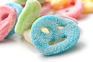 Acidulous candies in shaped smiley on white backgroun