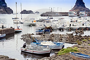 Acitrezza harbor with fisher boats next to Cyclops islands, Catania, Sicily, Italy