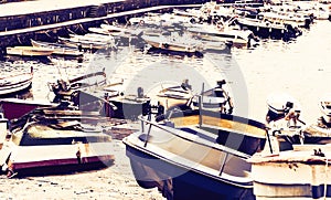 Acitrezza harbor with fisher boats next to Cyclops islands on sunset, Catania, Sicily, Italy