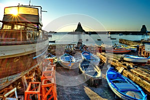 Acitrezza harbor with old boat