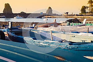 Acitrezza harbor with old boat