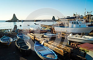 Acitrezza harbor with old boat