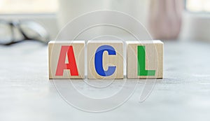 acl inscription on wooden cubes isolated on gray background.