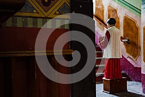 Acolyte with donation box for gifts in church