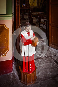 Acolyte with donation box for gifts in church