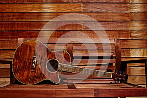 Acoustic brown guitar in wooden stripes